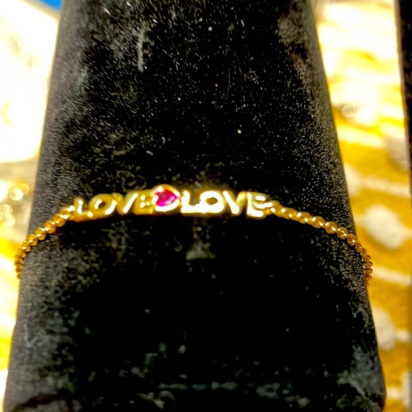 Very cute Kate Spade bracelet that says love twice with a pink stone in middle. - Picture 2 of 4